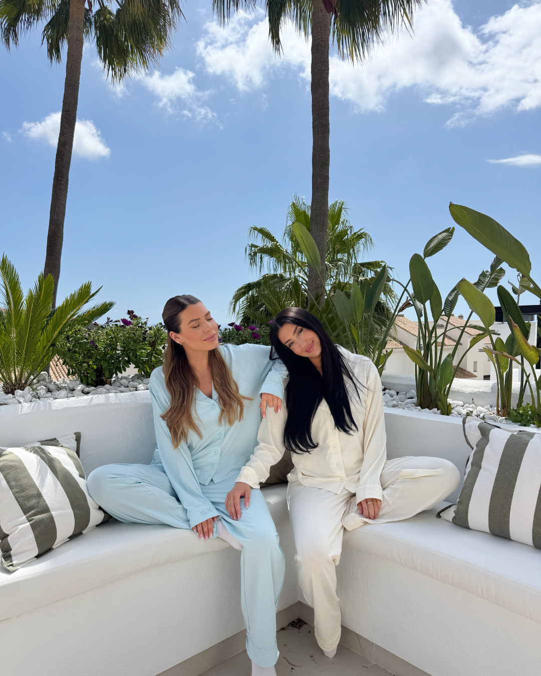 Two creators in Melowe pyjama sets on a sunlit terrace